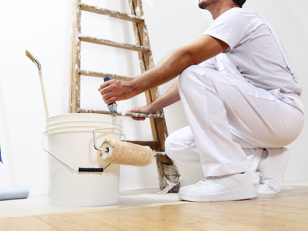 painter man at work with a roller, bucket and scale, bottom view